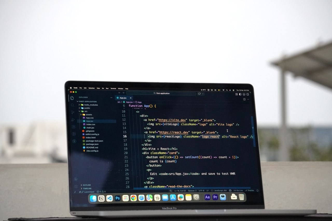 MacBook Pro displaying code on an outdoor terrace in Surat, India, showcasing remote work lifestyle.